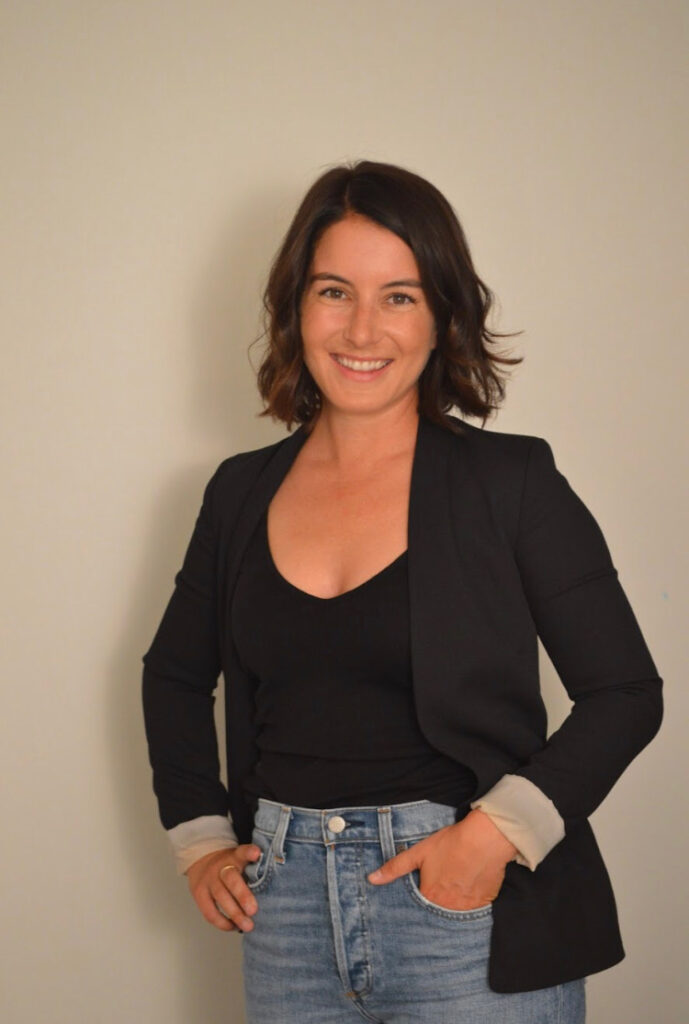 Val Hunter standing in a black blazer with jeans.